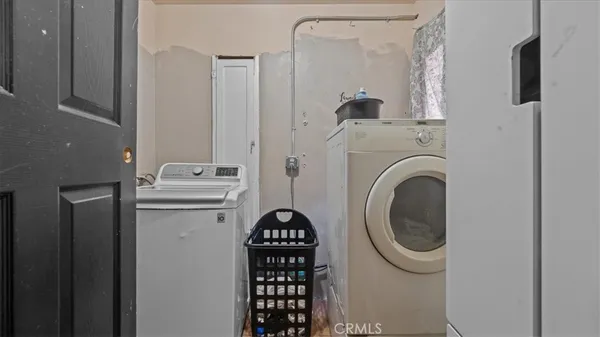 a view of a patio with table and chairs with wooden floor and fence