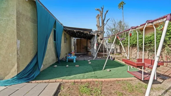a view of a patio with a table and chairs