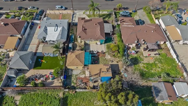 an aerial view of residential houses with outdoor space