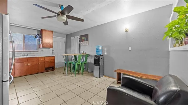 a work room with furniture and a potted plant