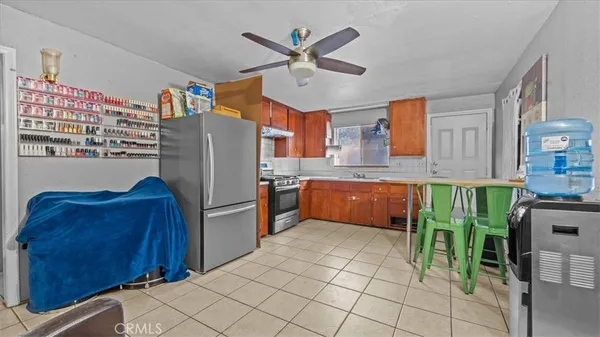 a kitchen with stainless steel appliances a stove a refrigerator and a sink