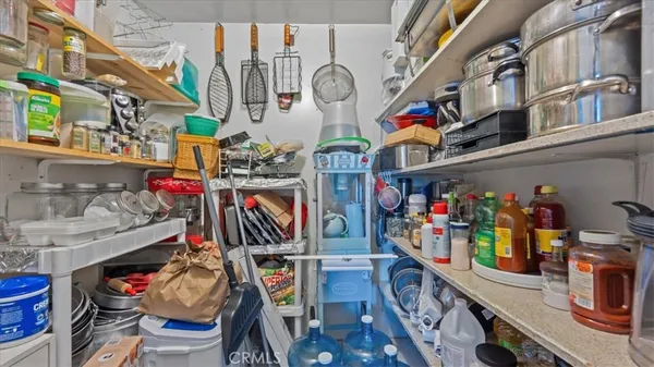 a bedroom with a bed a table and painting