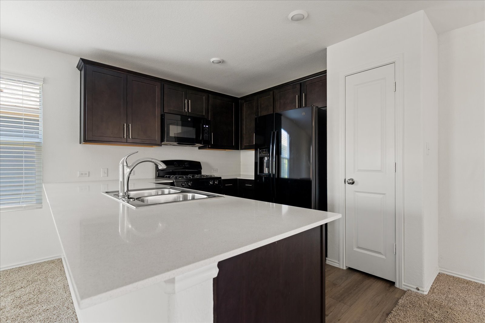 905 Powell Kyle, TX 78640 - Photo 13 of 37 a kitchen with a refrigerator and a sink
