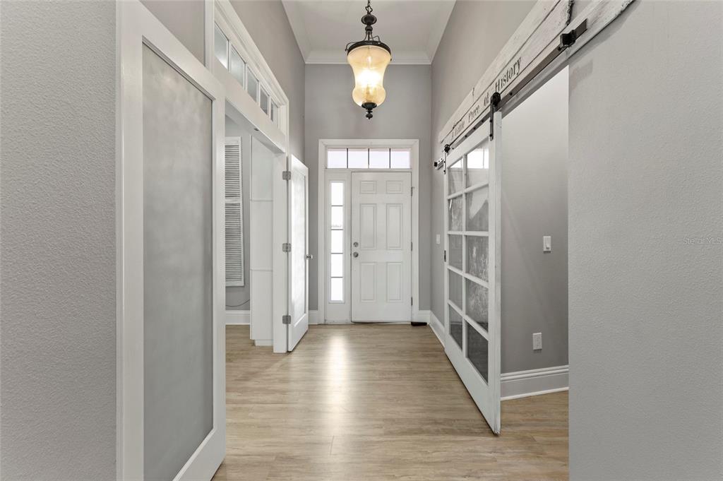 15710 Colding Loop Wimauma, FL 33598 - Photo 6 of 41 a view of a hallway with wooden floor and staircase