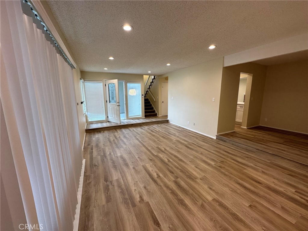 1155 Currier Avenue Simi Valley, CA 93065 - Photo 3 of 15 a view of an empty room with wooden floor and a window