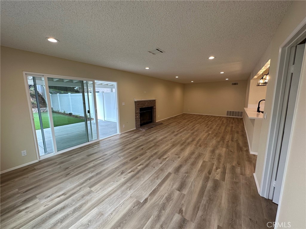 1155 Currier Avenue Simi Valley, CA 93065 - Photo 4 of 15 wooden floor in an empty room with a window