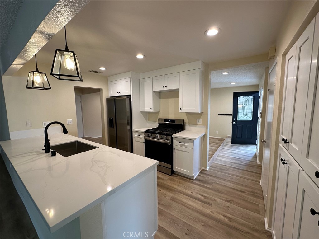 1155 Currier Avenue Simi Valley, CA 93065 - Photo 6 of 15 a kitchen with a refrigerator and a sink