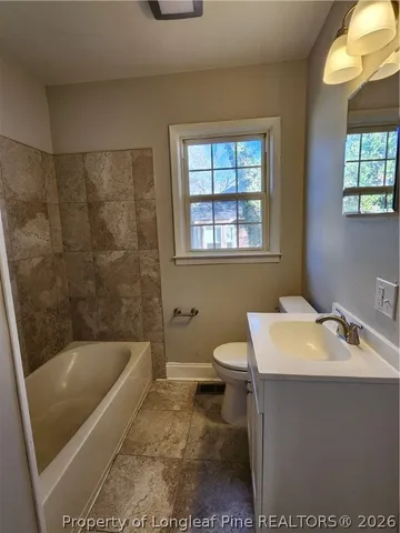 a bathroom with a sink a toilet and bathtub