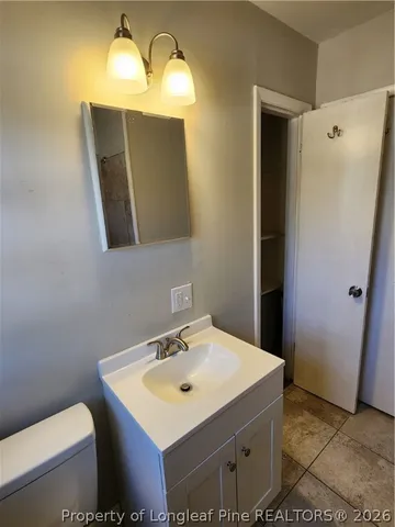 a bathroom with a sink toilet and mirror