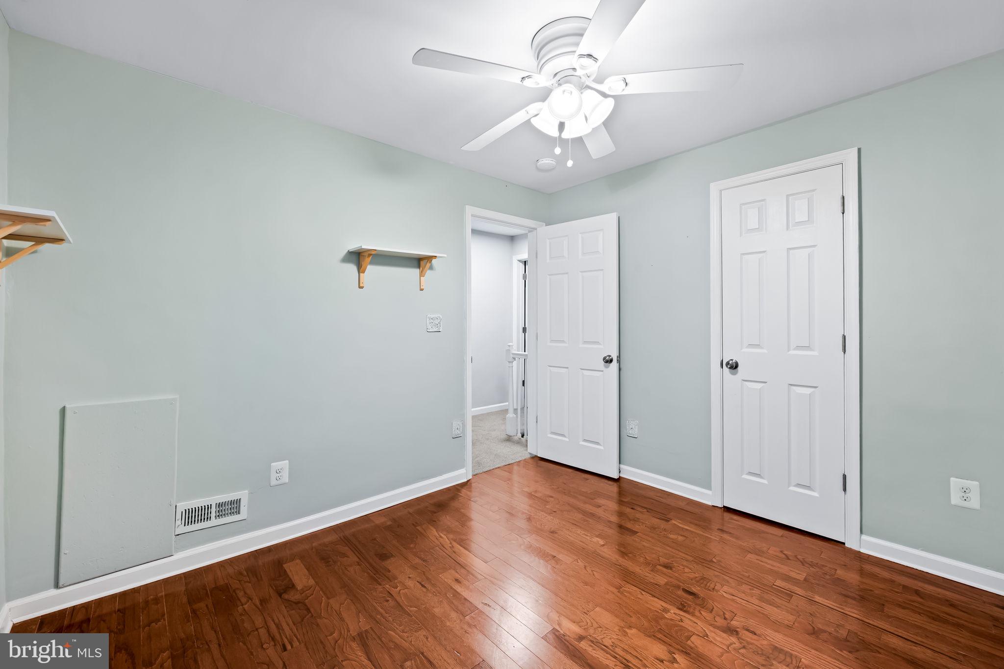 1817 Dunmere Road Baltimore, MD 21222 - Photo 18 of 27 wooden floor in an empty room with a window