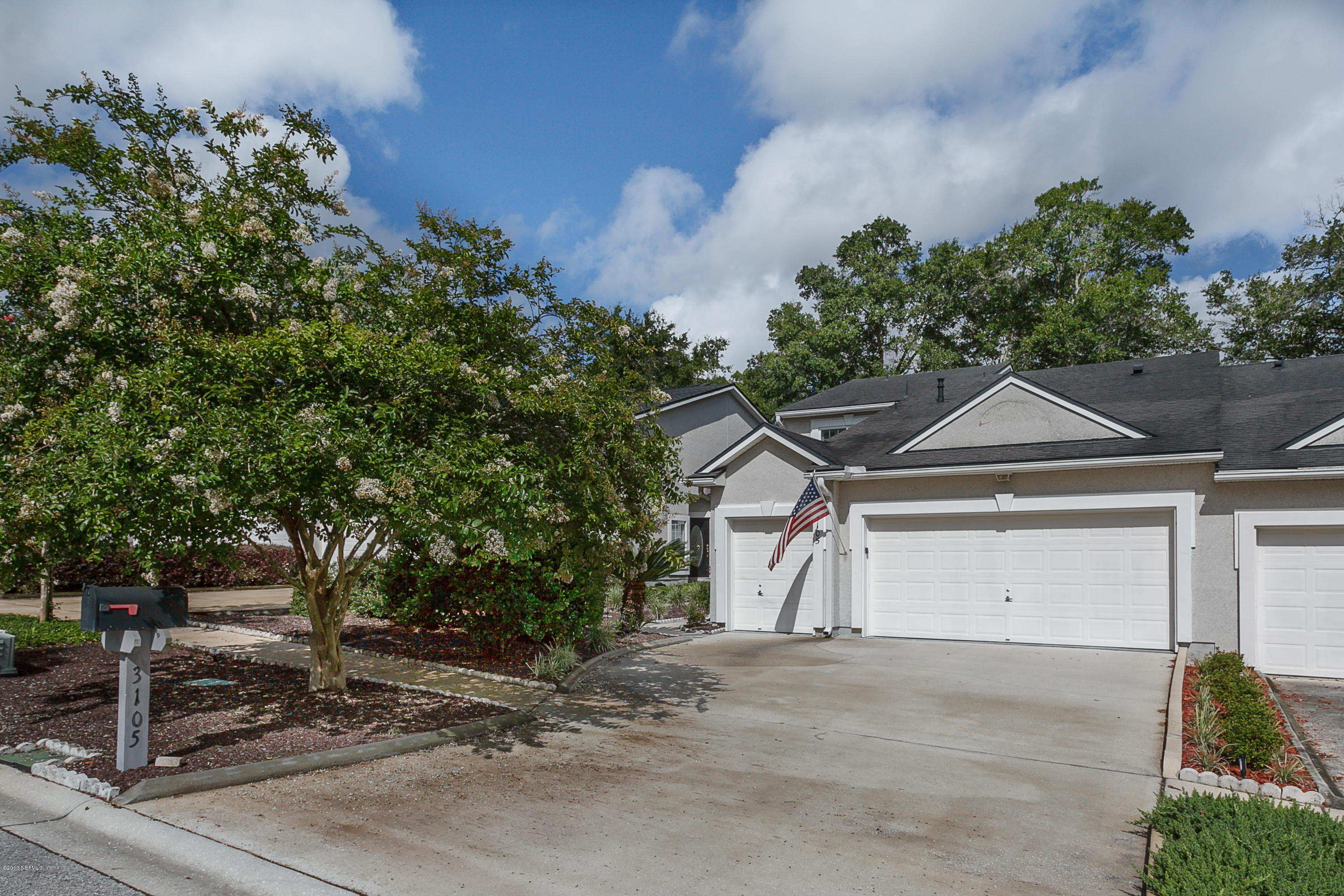 3105 Ravines Road Middleburg, FL 32068 - Photo 1 of 32 a front view of a house with a yard and garage