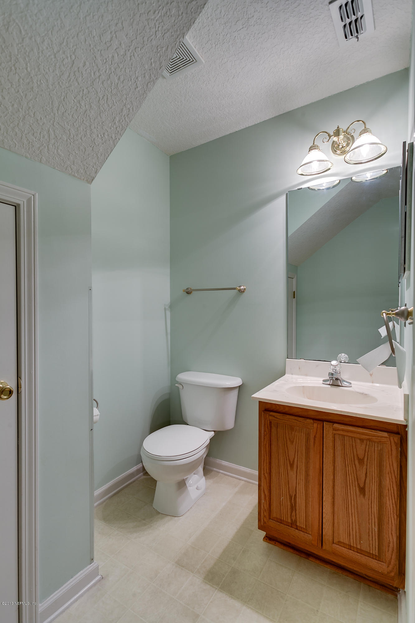 3105 Ravines Road Middleburg, FL 32068 - Photo 16 of 32 a bathroom with a sink toilet and a mirror