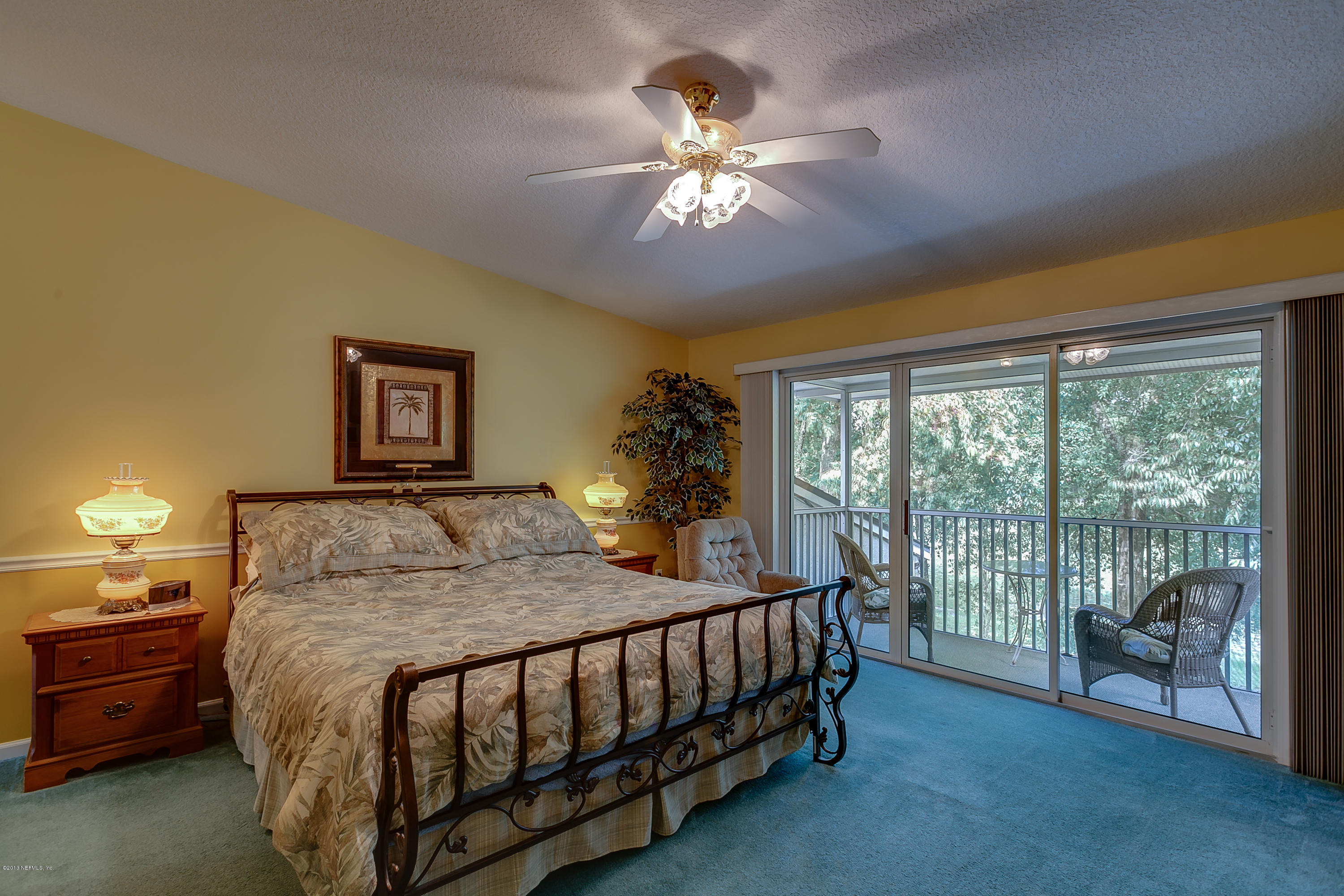 3105 Ravines Road Middleburg, FL 32068 - Photo 18 of 32 a bedroom with a bed and a chandelier