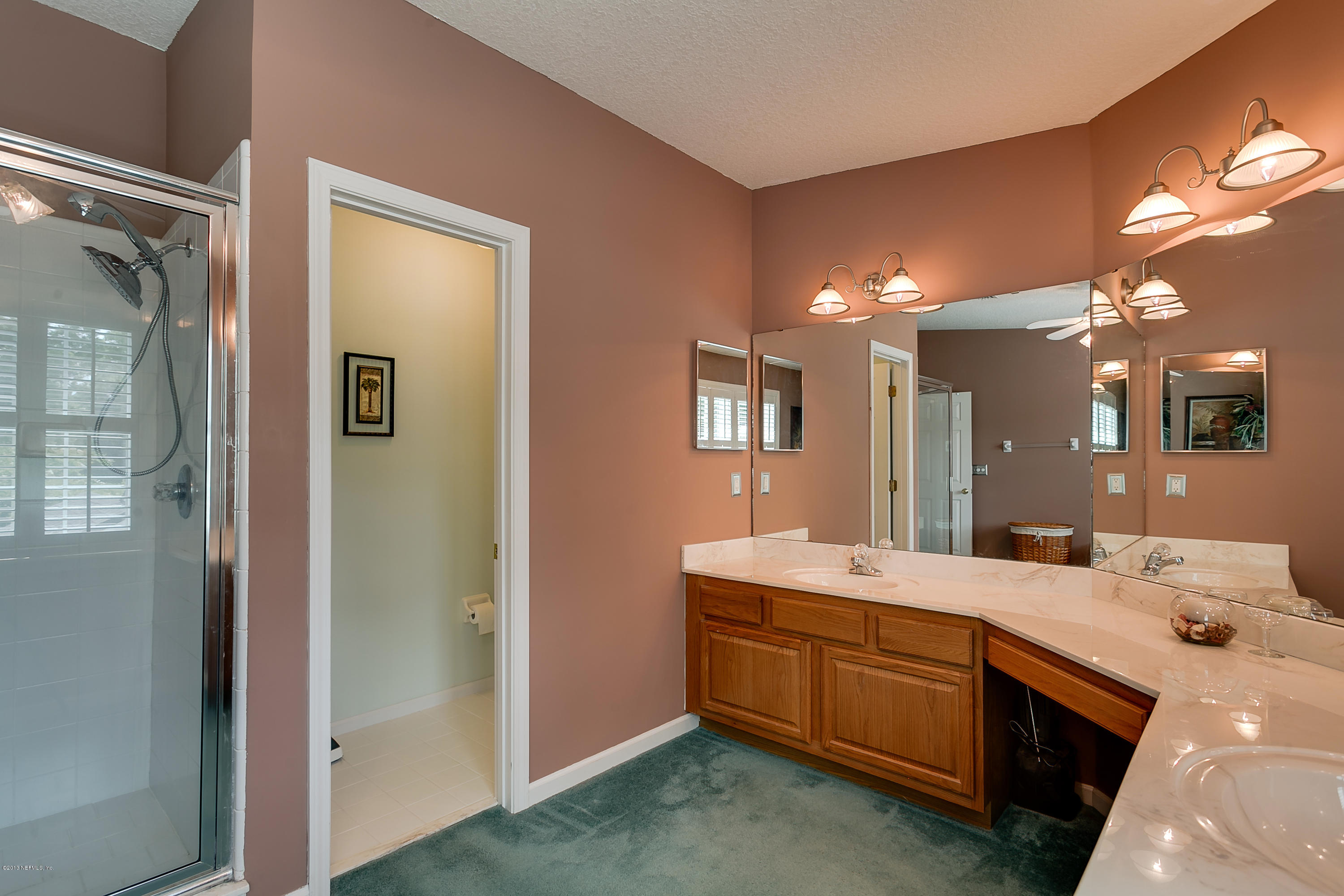 3105 Ravines Road Middleburg, FL 32068 - Photo 24 of 32 a bathroom with a double vanity sink and a mirror