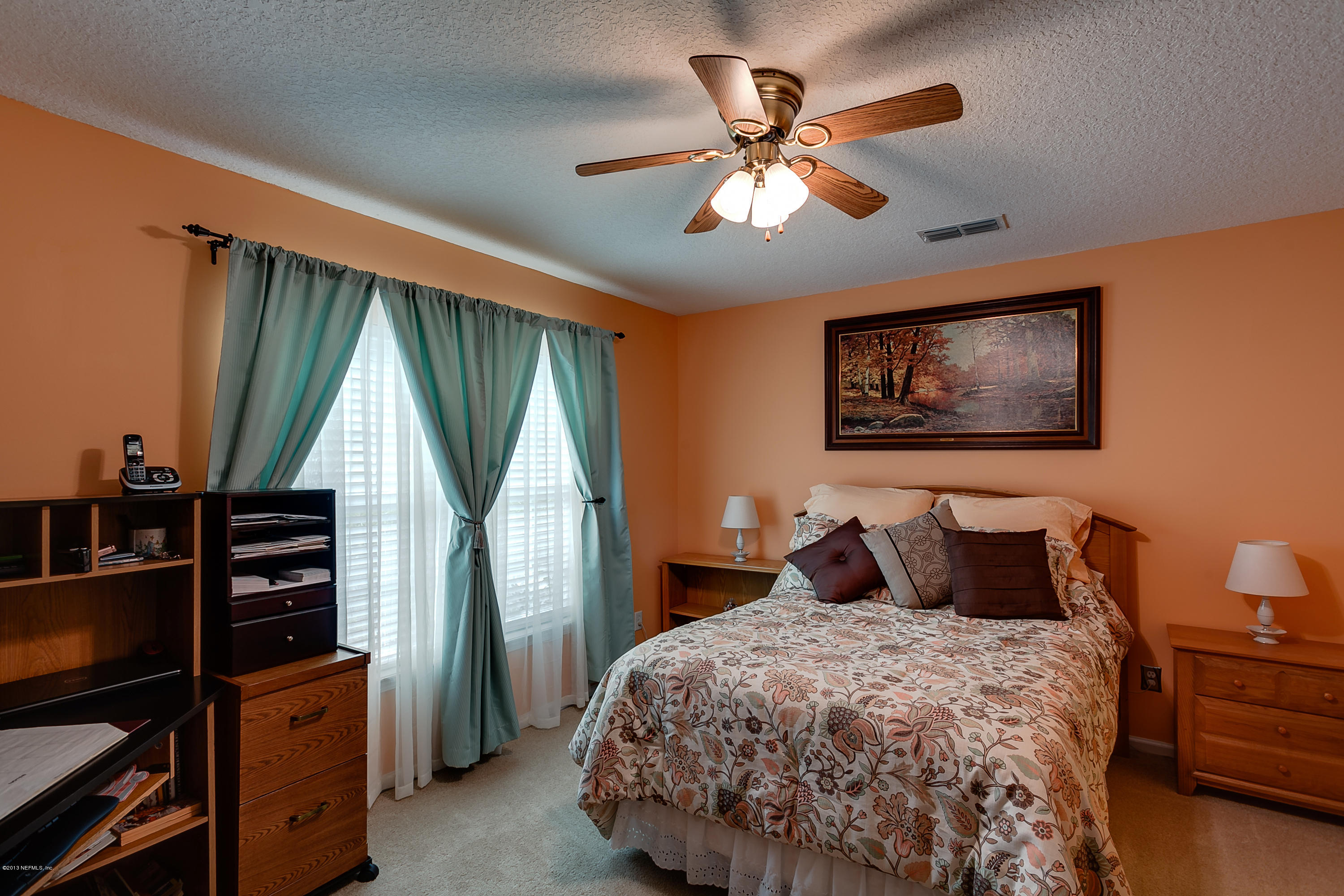 3105 Ravines Road Middleburg, FL 32068 - Photo 26 of 32 a bedroom with a bed a window and dresser
