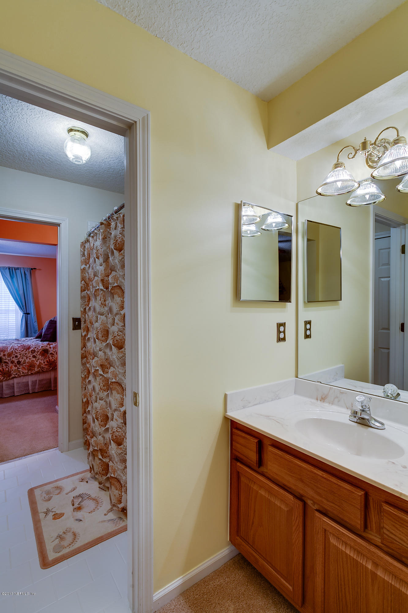 3105 Ravines Road Middleburg, FL 32068 - Photo 31 of 32 a bathroom with a sink a large mirror and a shower