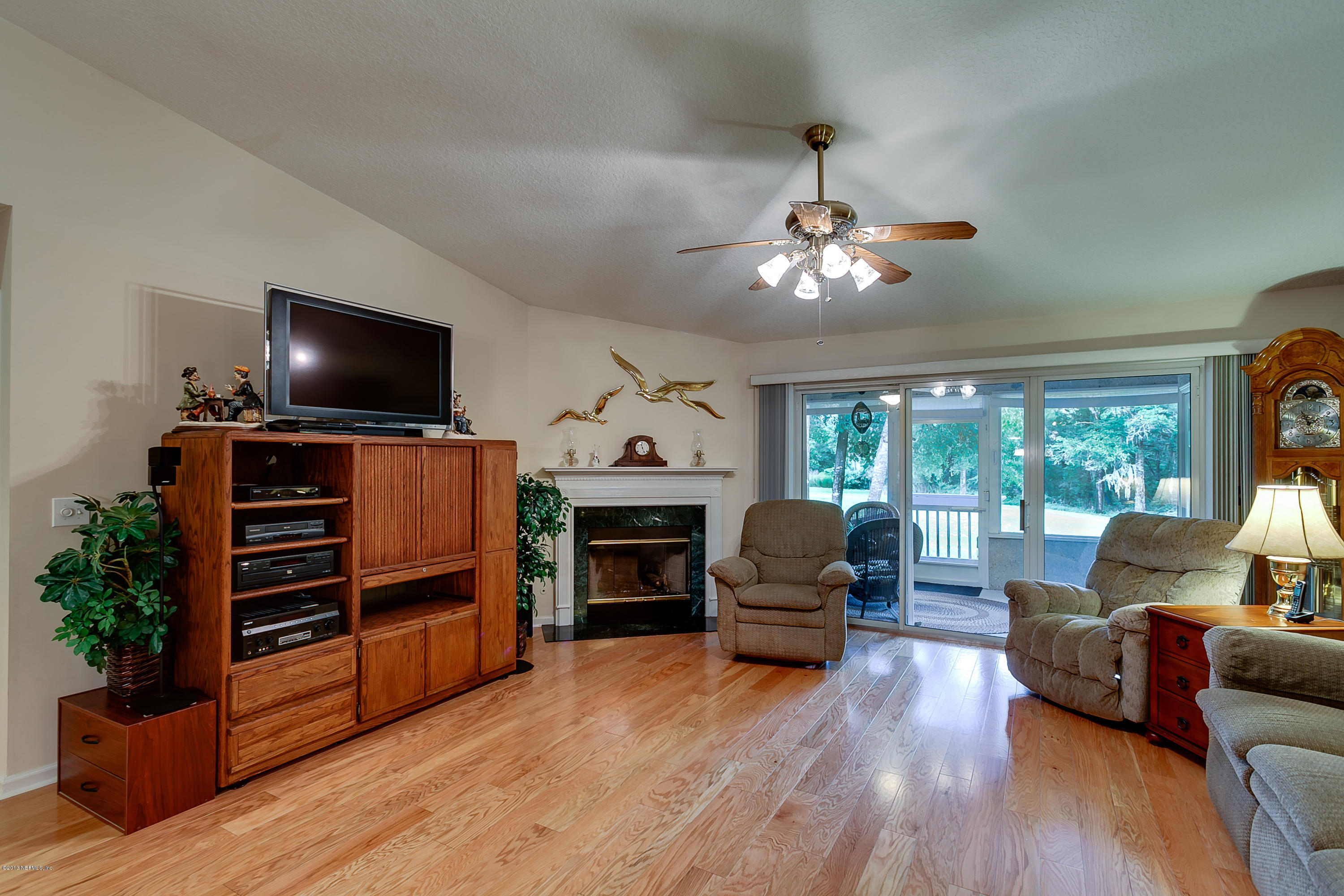 3105 Ravines Road Middleburg, FL 32068 - Photo 4 of 32 a living room with furniture and a flat screen tv