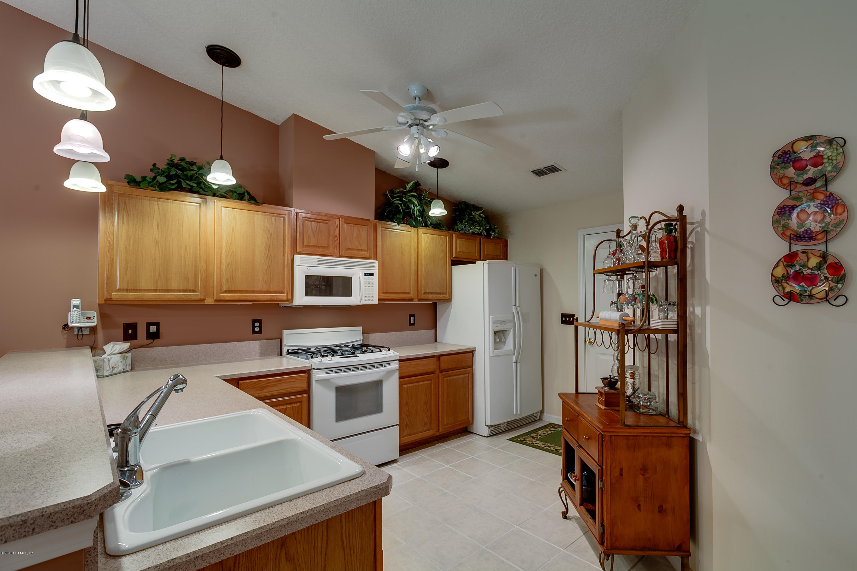 3105 Ravines Road Middleburg, FL 32068 - Photo 6 of 32 a kitchen with stainless steel appliances granite countertop a refrigerator and a stove top oven
