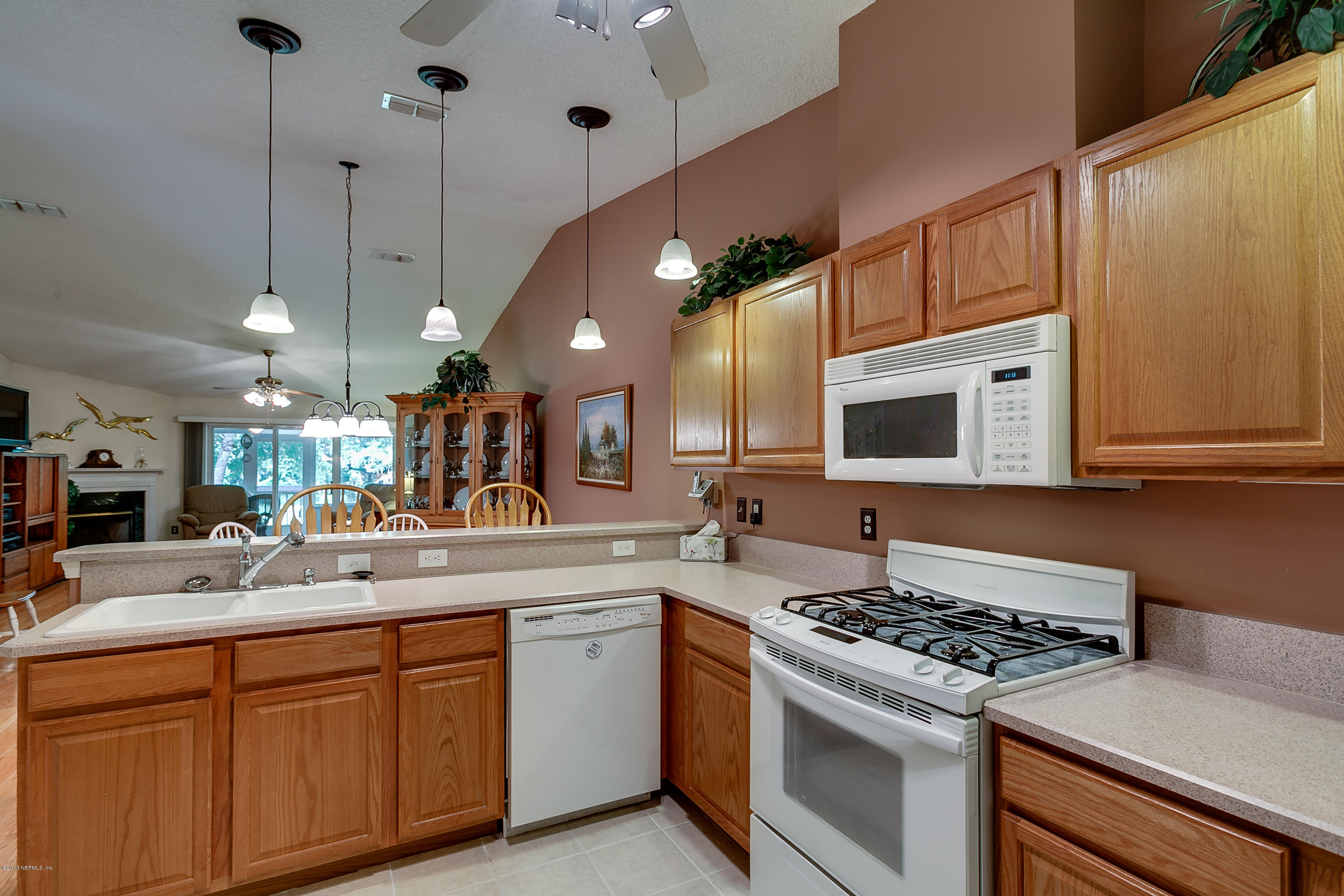 3105 Ravines Road Middleburg, FL 32068 - Photo 7 of 32 a kitchen with stainless steel appliances granite countertop a sink a stove and a microwave oven