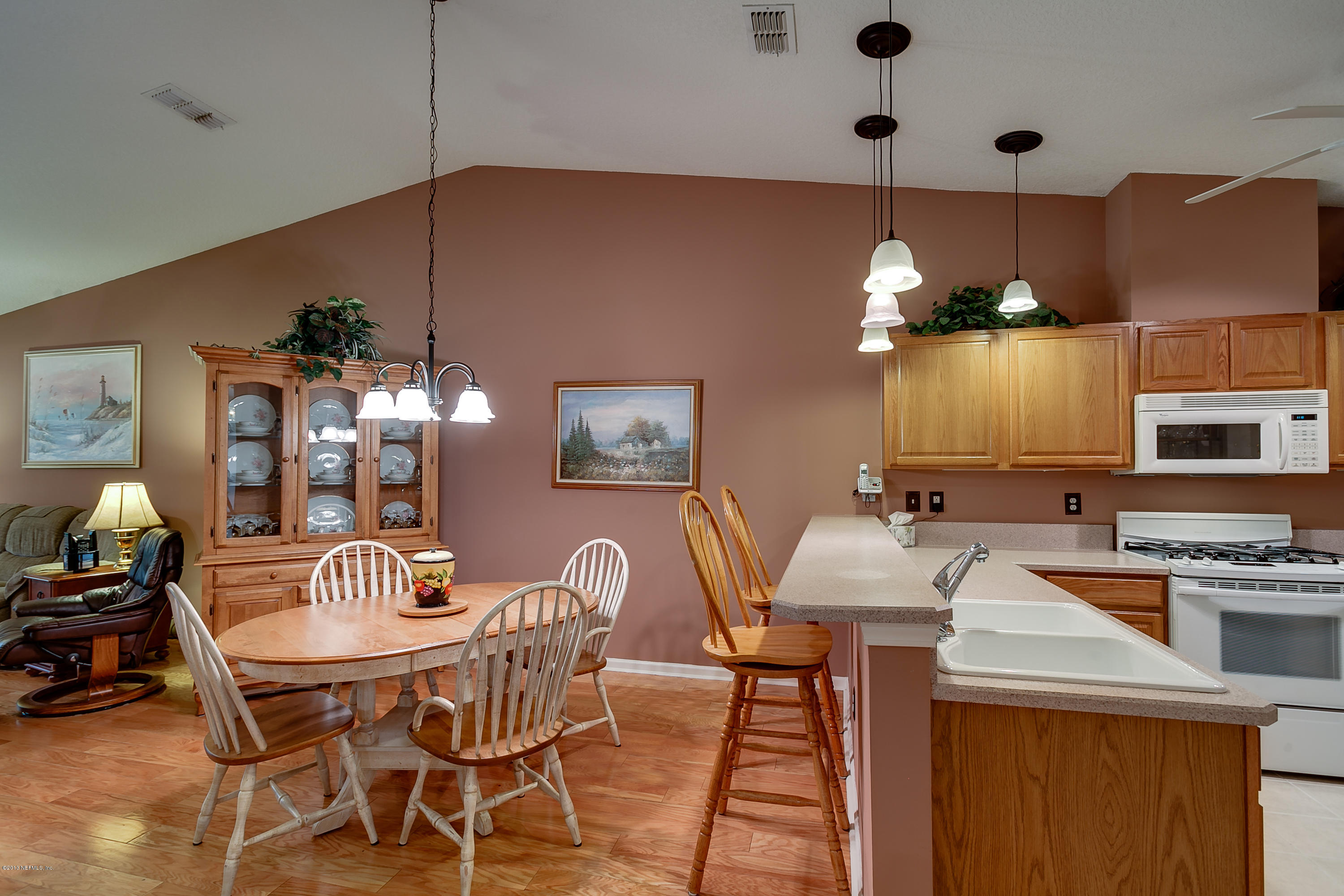 3105 Ravines Road Middleburg, FL 32068 - Photo 9 of 32 a dining room with furniture and chandelier