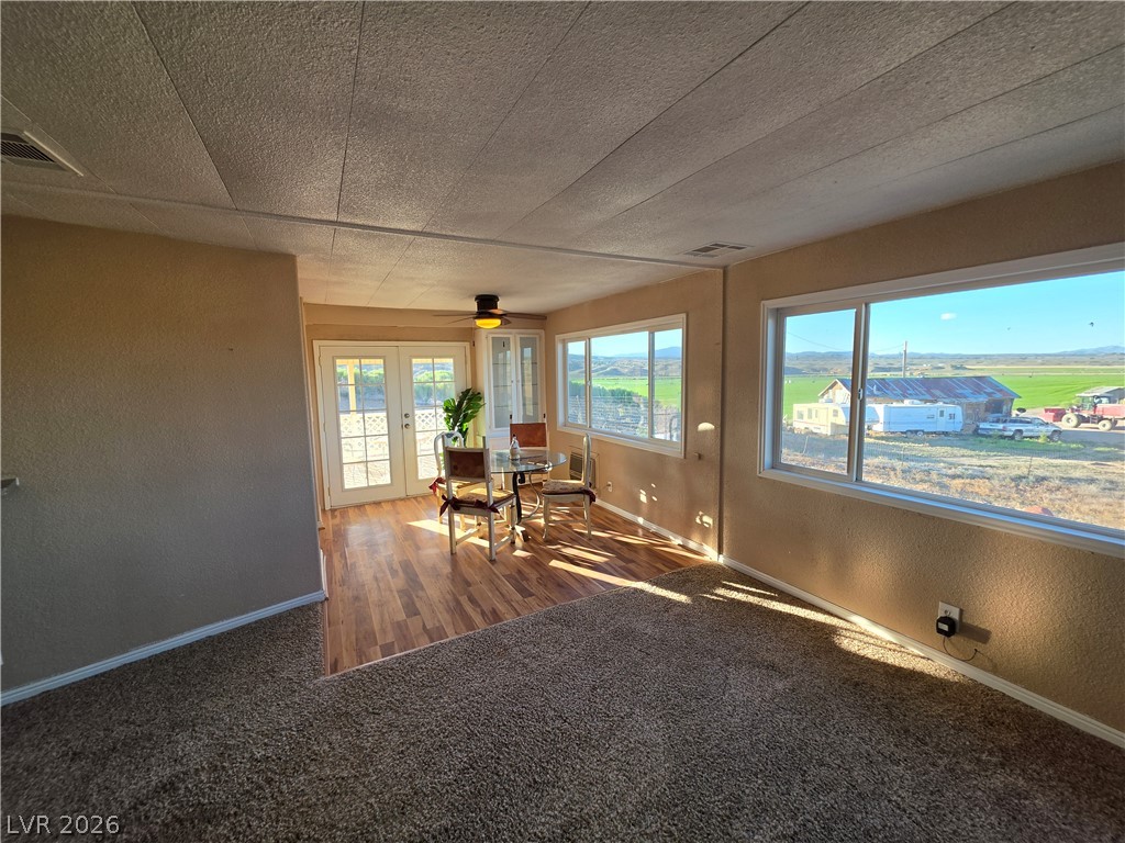 2930 Frehner Ranch Road Pioche, NV 89043 - Photo 5 of 32 Natural light floods this versatile living area, featuring French doors and a picturesque rural outlook.
