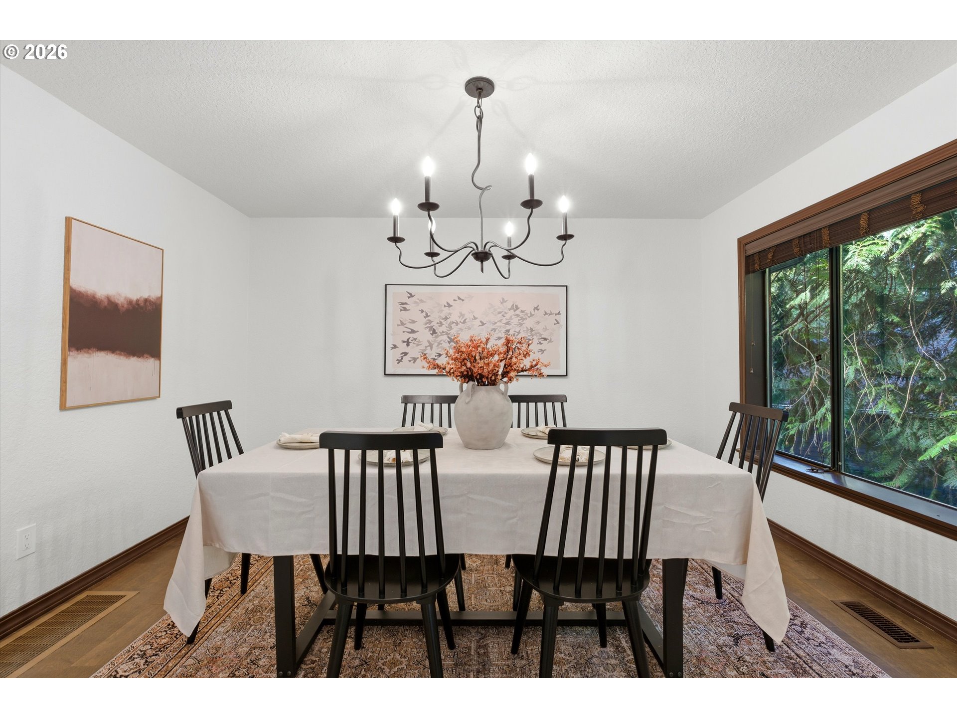 7236 Southeast 133rd Place Portland, OR 97236 - Photo 14 of 42 a view of a dining room with furniture a chandelier and wooden floor
