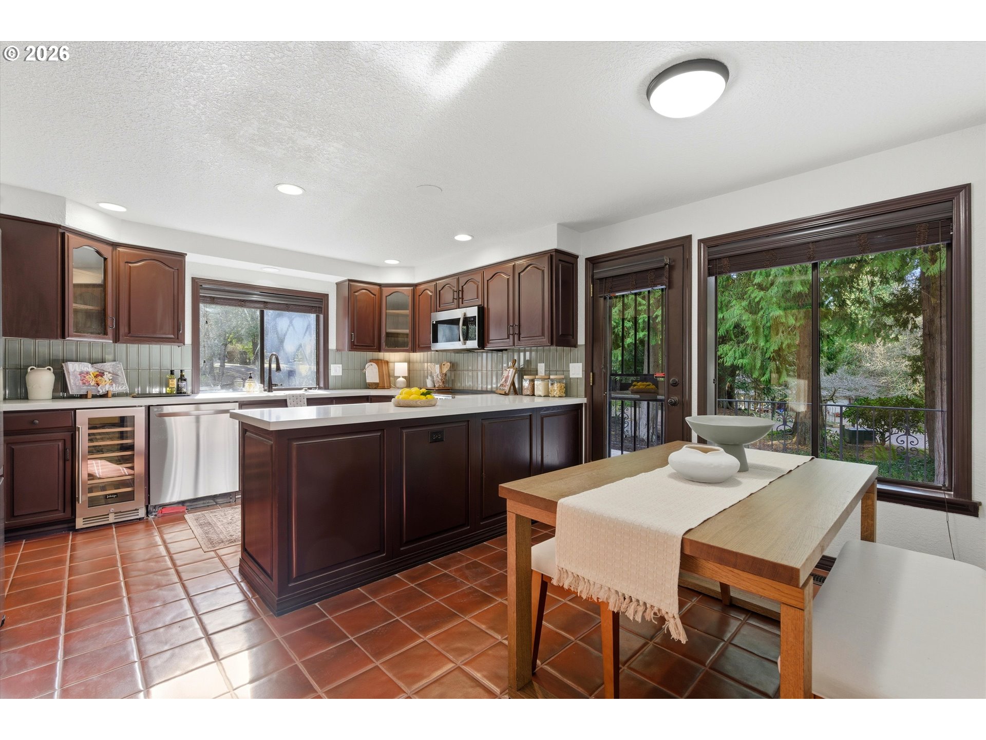 7236 Southeast 133rd Place Portland, OR 97236 - Photo 15 of 42 a kitchen with a sink dining table and chairs