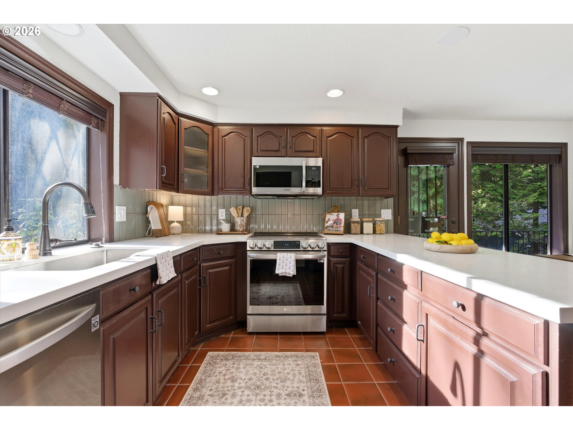 7236 Southeast 133rd Place Portland, OR 97236 - Photo 17 of 42 a kitchen with stainless steel appliances granite countertop a stove sink and cabinets