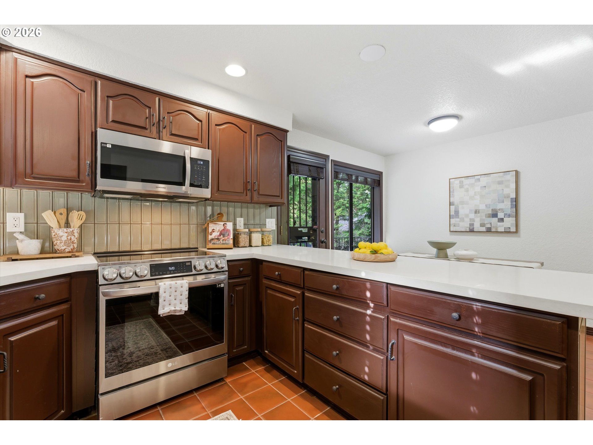 7236 Southeast 133rd Place Portland, OR 97236 - Photo 18 of 42 a kitchen with stainless steel appliances granite countertop a stove a sink and a microwave