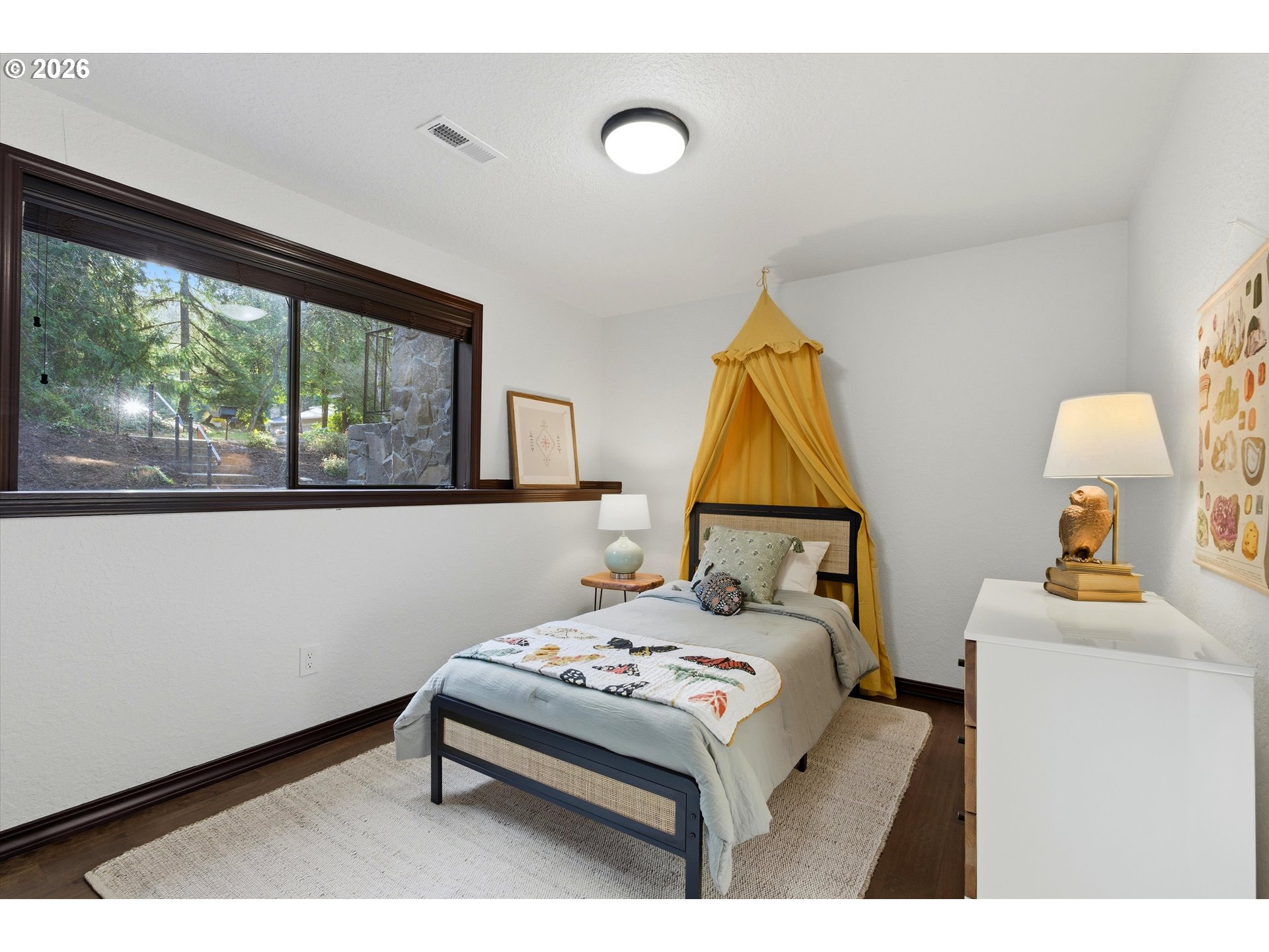 7236 Southeast 133rd Place Portland, OR 97236 - Photo 32 of 42 a bedroom with a bed and a painting on the wall