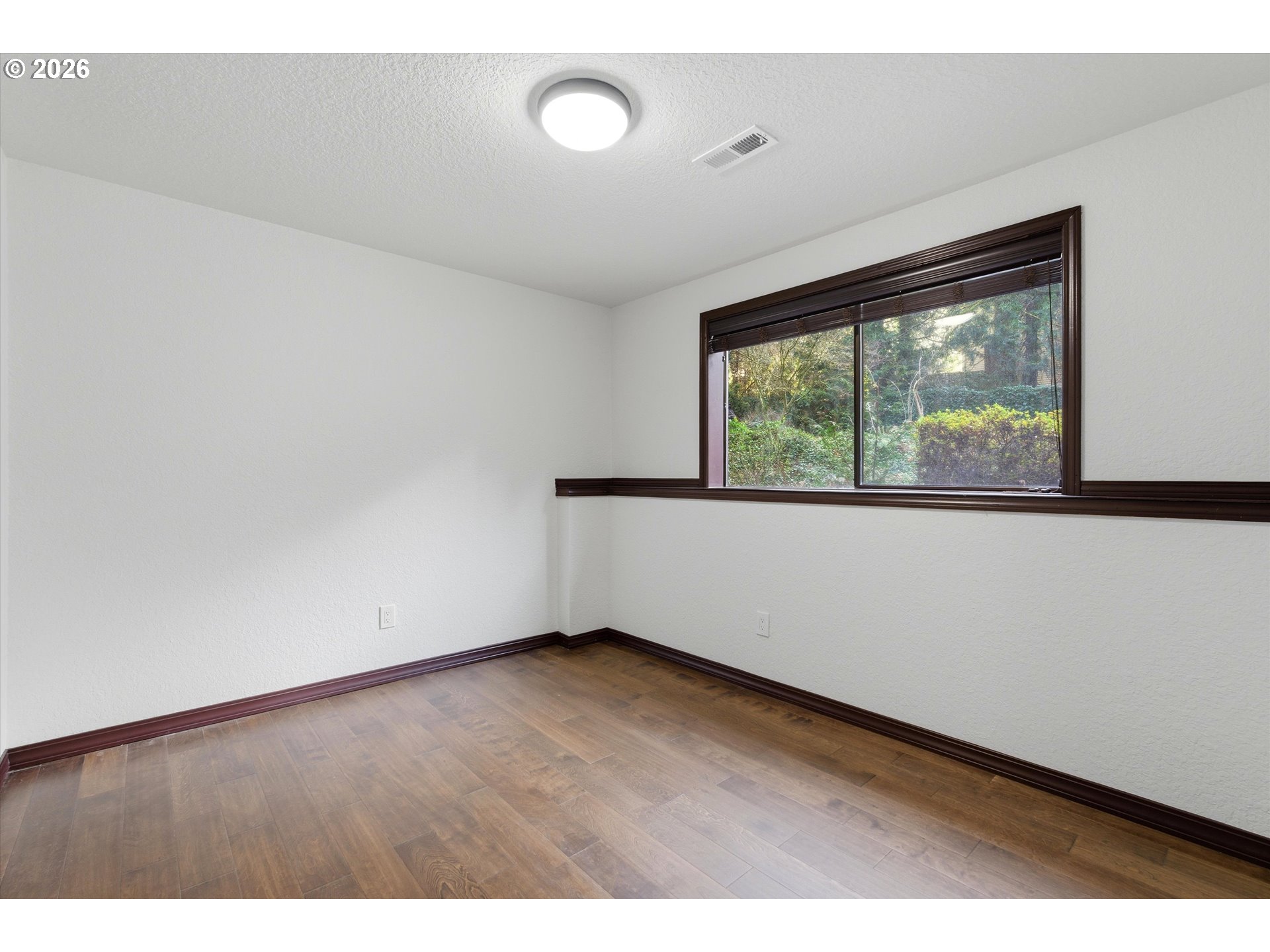 7236 Southeast 133rd Place Portland, OR 97236 - Photo 35 of 42 an empty room with wooden floor and windows