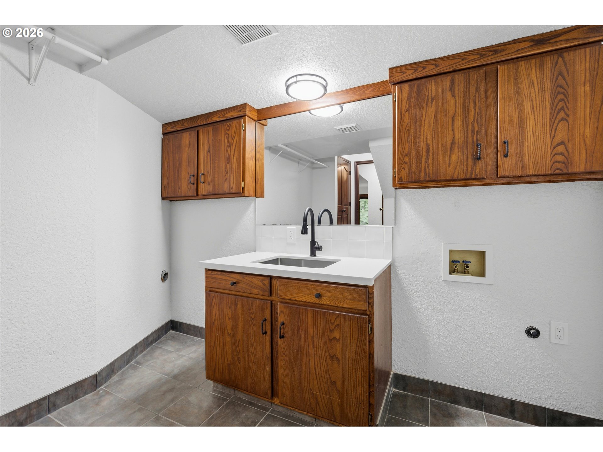 7236 Southeast 133rd Place Portland, OR 97236 - Photo 41 of 42 a kitchen with a sink and cabinets
