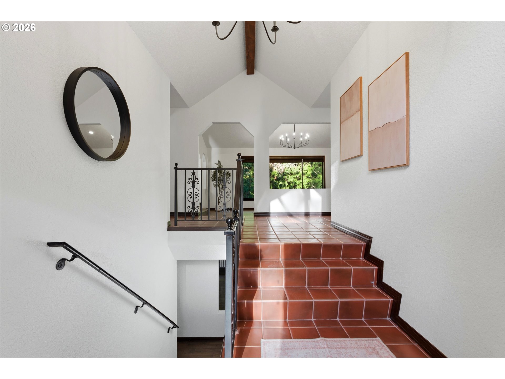 7236 Southeast 133rd Place Portland, OR 97236 - Photo 8 of 42 a living room with a black white checkered floor with a large mirror and potted plants on the wall