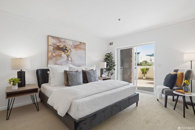 a bathroom with a granite countertop sink mirror vanity and toilet