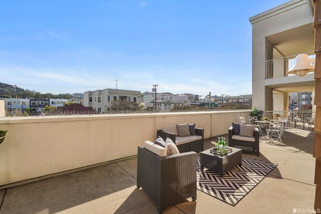 a living room with furniture and a lamp