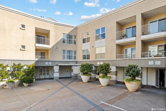a view of a house with sitting area and potted plants