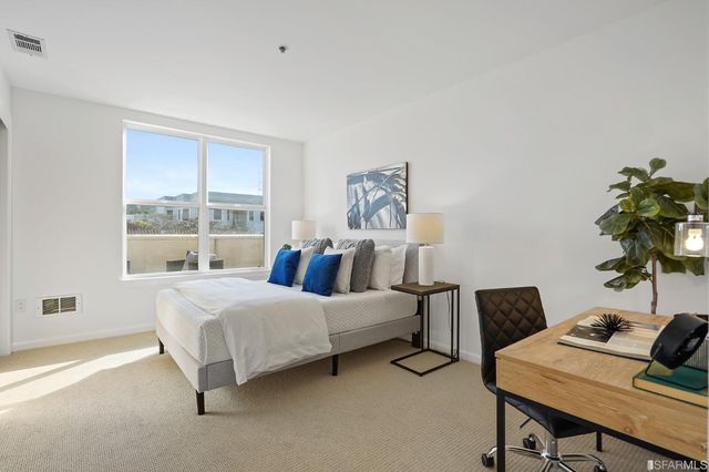 a bedroom with a bed and chair