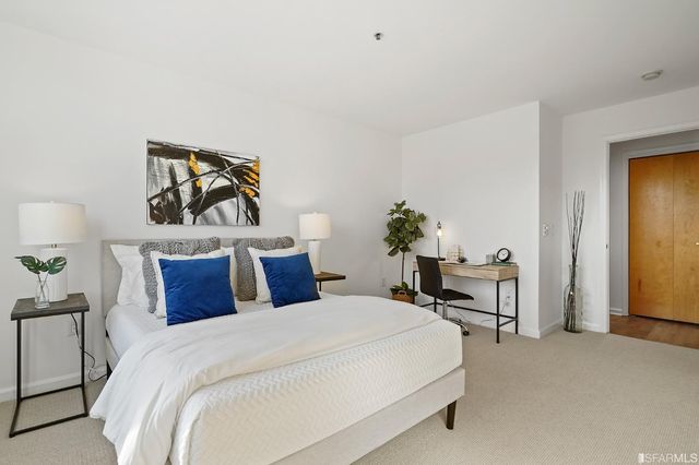 a bedroom with a bed and a lamp on table