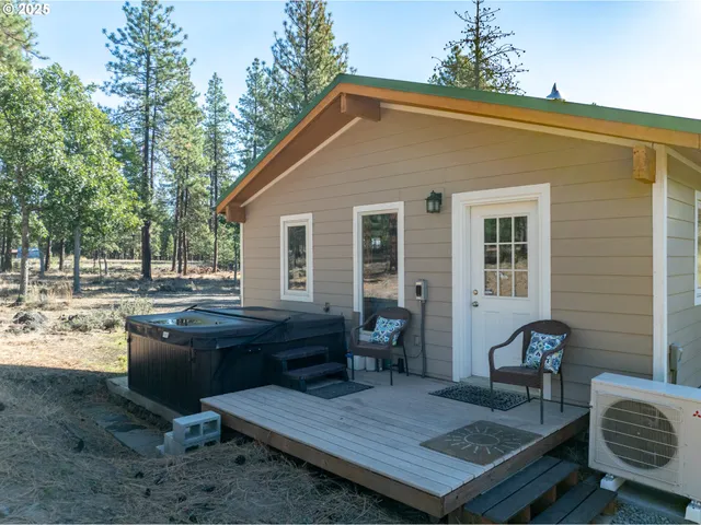 a view of a deck with table and chairs with wooden floor and fence