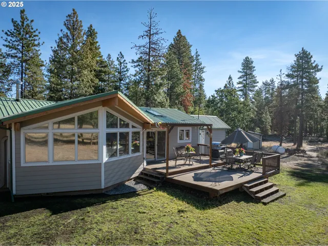 a view of a house with swimming pool and sitting area
