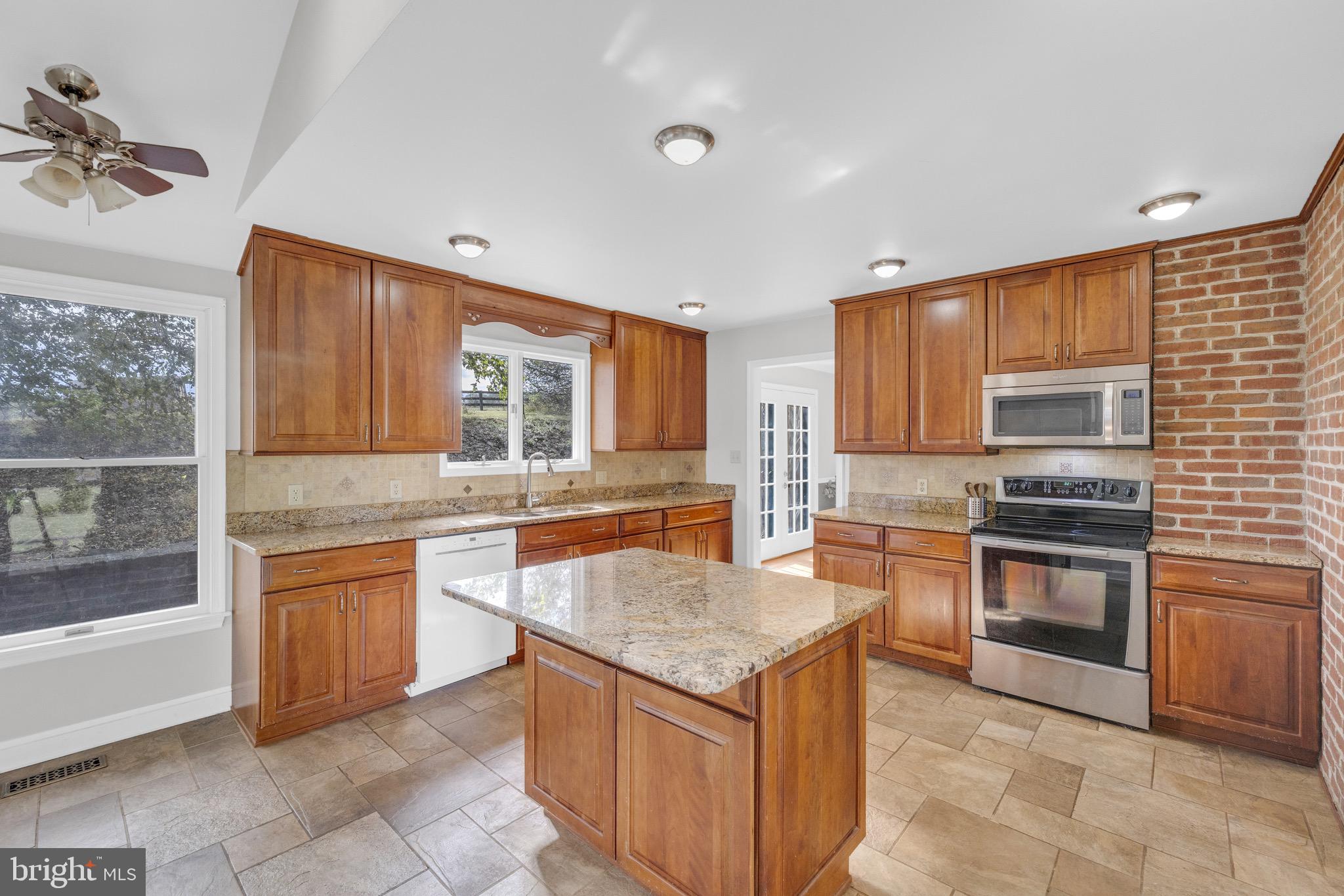 8729 Green Road Warrenton, VA 20187 - Photo 15 of 42 a kitchen with stainless steel appliances granite countertop a stove top oven sink and cabinets