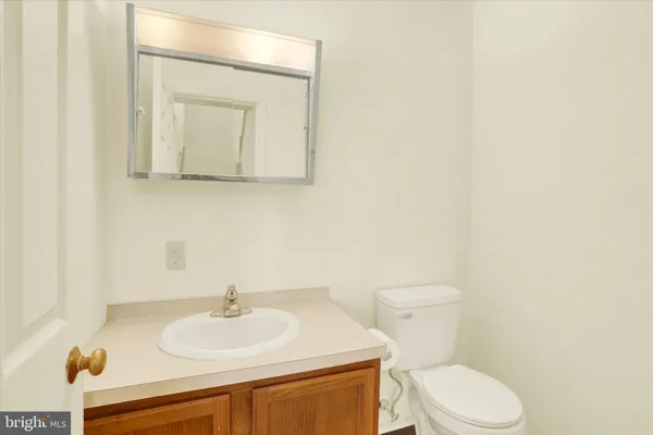 a bathroom with a sink a toilet and mirror