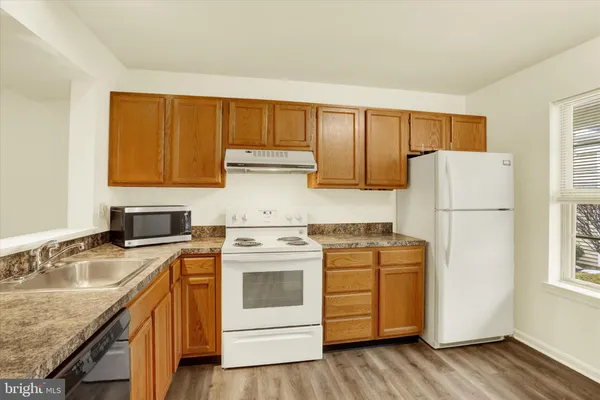 a kitchen with a sink a stove and refrigerator
