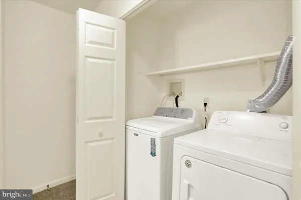 a view of storage and utility room with washer and dryer