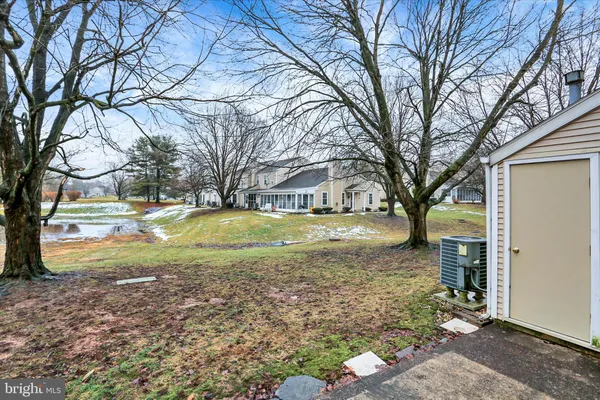 a view of yard with tree in the background