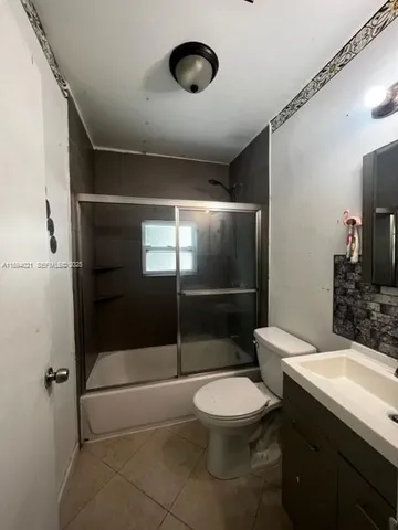 a bathroom with a toilet sink and shower