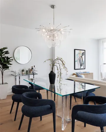 a view of a dining room with furniture and chandelier