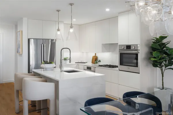 a kitchen with a table chairs a sink and dishwasher