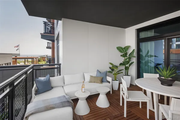 a living room with furniture and potted plant