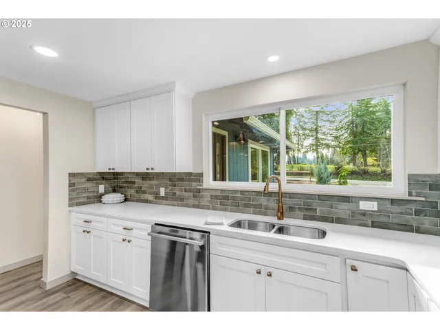 a kitchen with a sink and large window